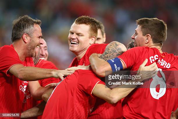 John Arne Riise and Steven Gerrard congratulate Ian Rush of the Liverpool FC Legends as he celebrates with is team mates after scoring a goal during...