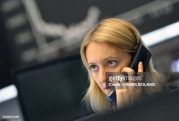 Trader works in front of a board displaying the chart of Germany's share index DAX at the stock exchange in Frankfurt am Main, western Germany, on...