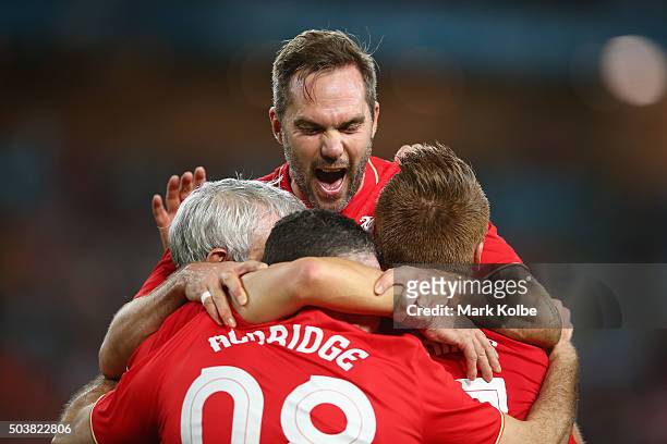 Jason McAteer of the Liverpool FC Legends jumps to celebrate with his team after John Aldridge of the Liverpool FC Legends scored a goal during the...