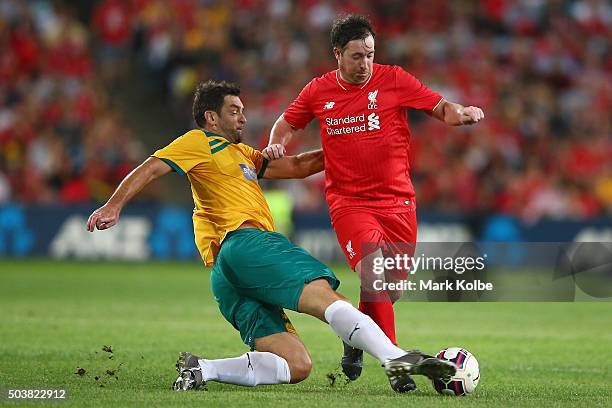 Ned Zelic of the Australian Legends tackles Robbie Fowler of the Liverpool FC Legends uring the match between Liverpool FC Legends and the Australian...