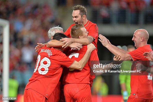 John Aldridge of the Liverpool Legends celebrates with his team mates after scoring a goal during the match between Liverpool FC Legends and the...