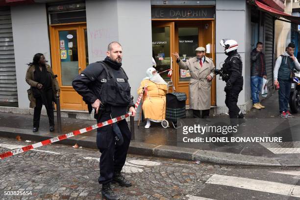 French police patrol near the Boulevard de Barbes in the north of Paris on January 7 after police shot a man dead as he was trying to enter a police...