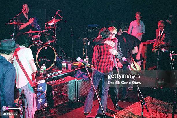 Musician Ryan Adams hugging special guest, singer Elton John at Irving Plaza.