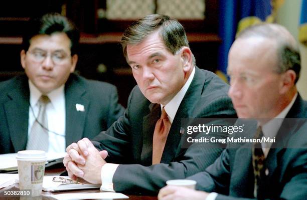 Tom Ridge , newly sworn-in director of the Office of Homeland Security, White House Counsel Alberto R. Gonzales & OMB Dir. Mtchell Daniels attending...