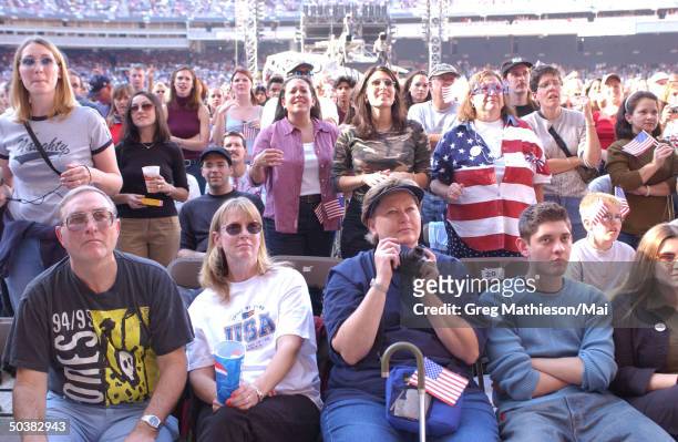 Spectators showing their American spirit at the United We Stand What More Can I Give concert at RFK Stadium for the victims of the September 11th...