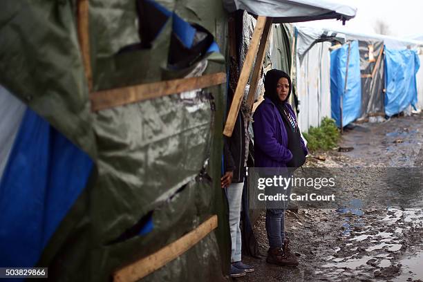 An Eritrean woman looks on after a Christmas service at a church in the camp known as 'The Jungle' on January 7, 2016 in Calais, France. Orthodox...