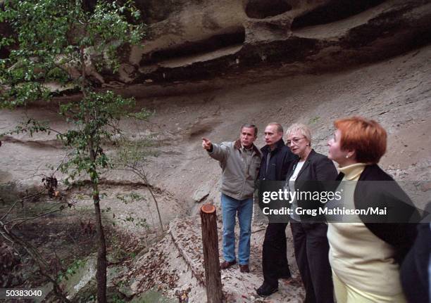 President George W. Bush, Russian President Vladimir Putin, interpreter Irene Firsow and Russian First Lady Lyudmila Putin touring a canyon and...