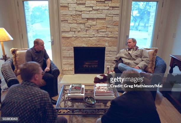 President George W. Bush and Russian President Vladimir Putin w. American and Russian interpreters meeting inside a guest room of the Bush Ranch.