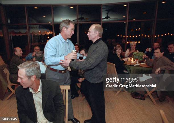 President George W. Bush and Russian President Vladimir Putin sharing a toast at the conclusion of dinner at the Bush Ranch.