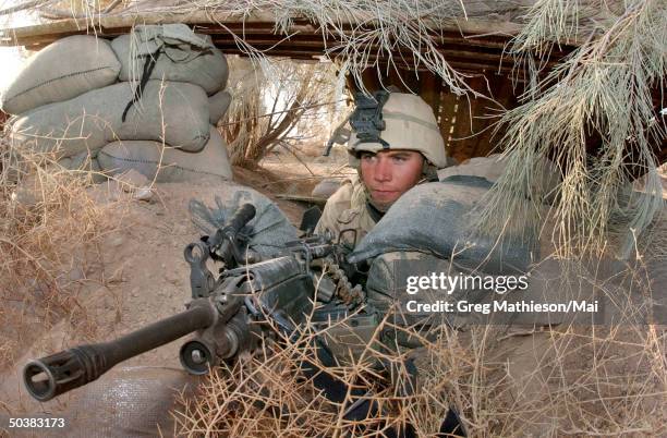 LCpl. Chris Cassa positioning his weapon in place as he gears up for the evening watch. LCpl Cassa of India Company, 26 MEU has been in the fields of...