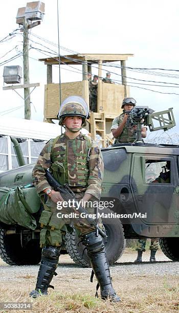 Marine security teams taking up positions during a rehearsal for handling incoming detainees at Camp X-Ray, one of the holding facilities for Taliban...