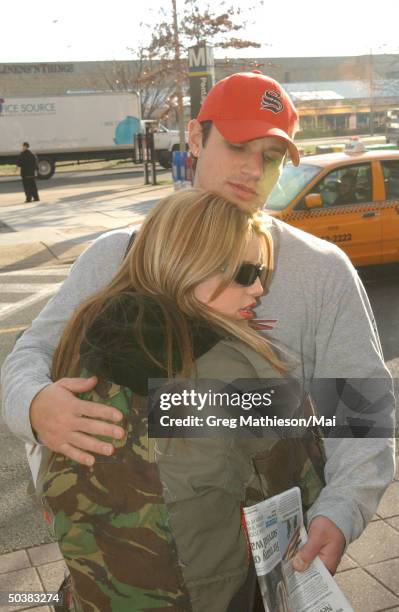 Singer Jessica Simpson hugging boyfriend, singer for 98 Degrees, Nick Lachey before leaving on USO tour to entertatin US troops overseas during the...
