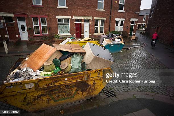 Skips line the roads as the clear up and rebuilding of flood damaged property and homes continues one month on from the devasting floods created by...