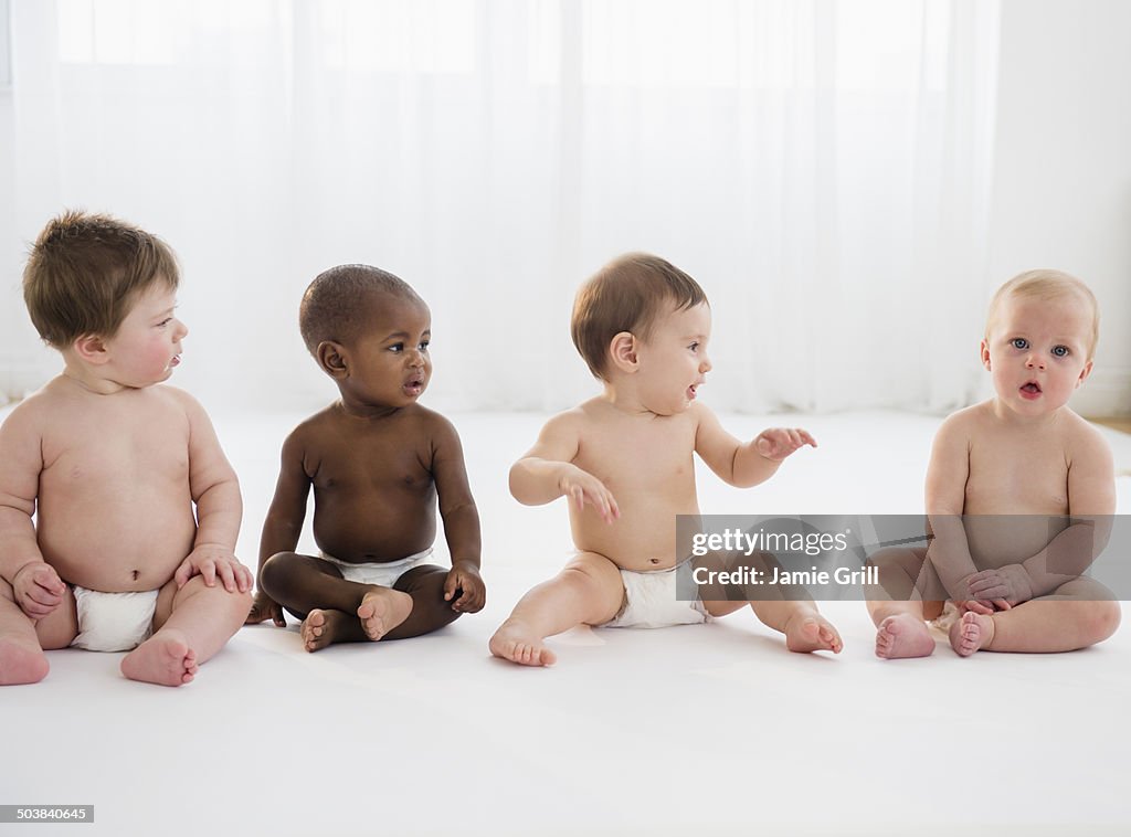 Babies sitting on floor