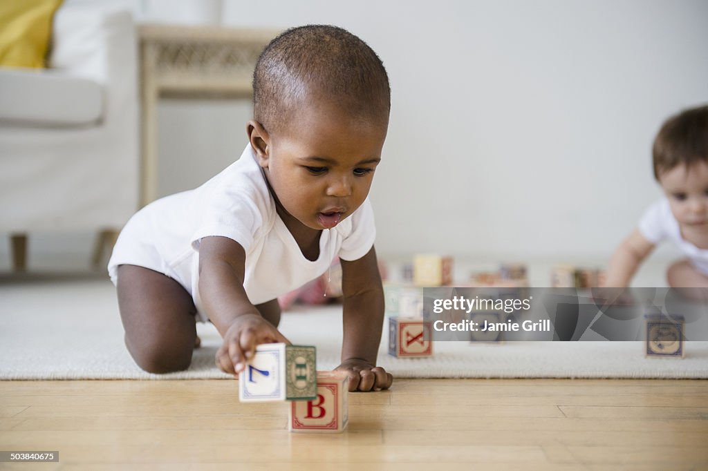 Babies playing with blocks