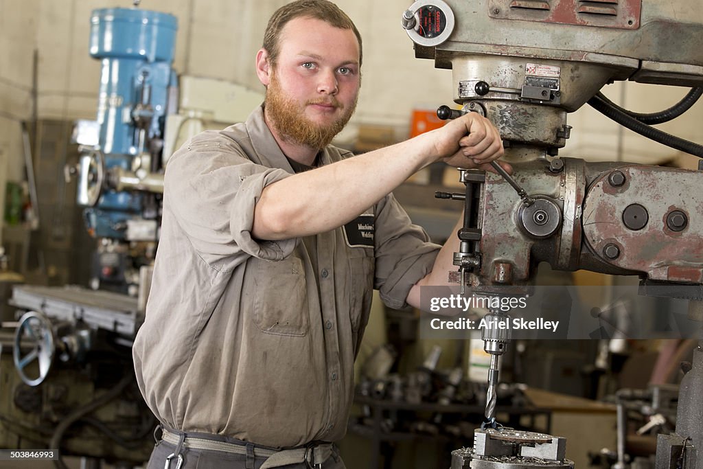 Caucasian machinist working in garage