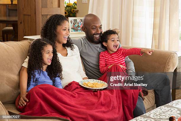 family watching television together - african watching tv foto e immagini stock