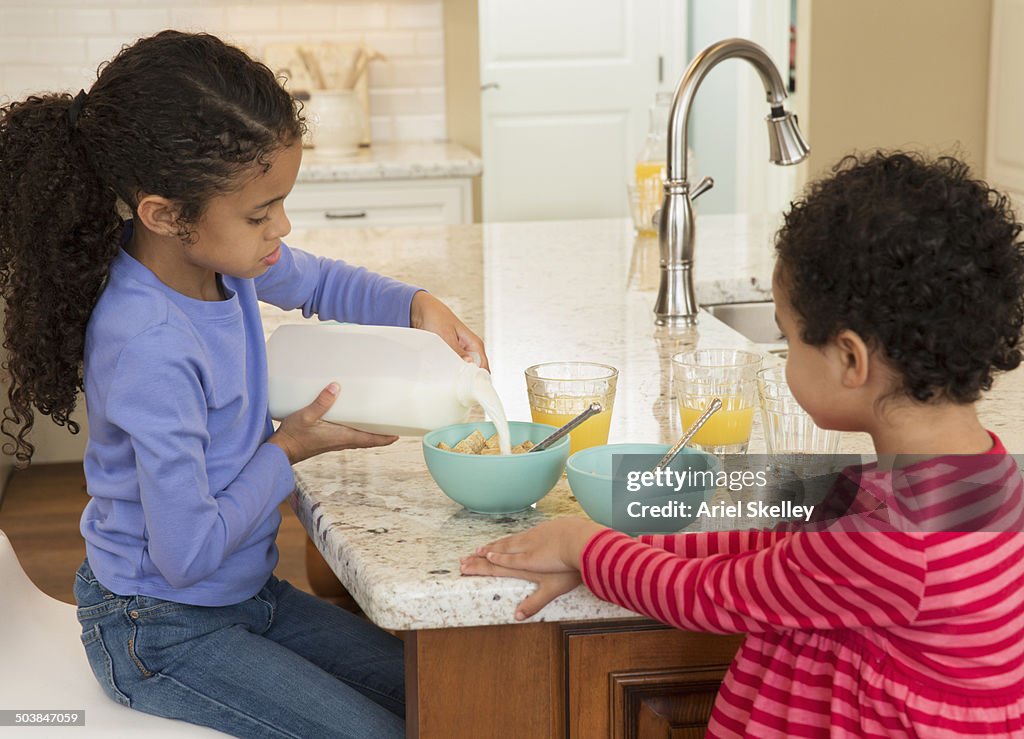 Mixed race girls having breakfast together