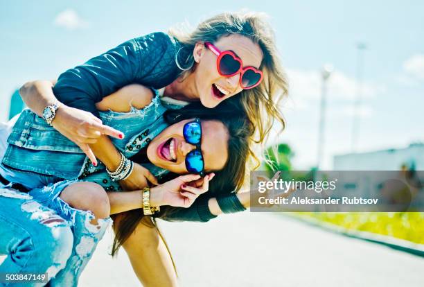 women playing on city street - 2 people playing joke imagens e fotografias de stock