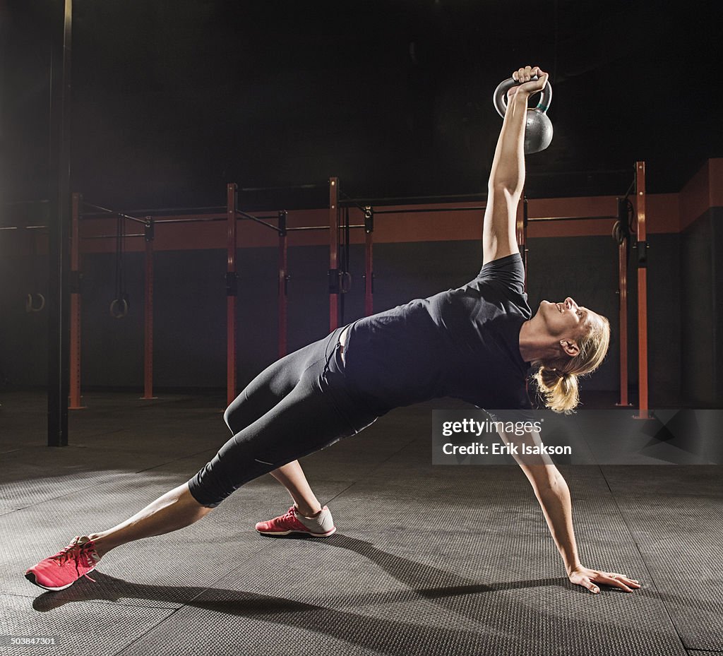 Caucasian woman lifting weights in gym