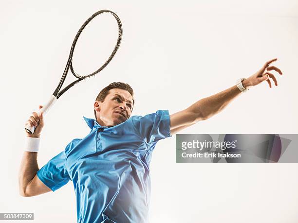 caucasian man playing tennis - human arm stock pictures, royalty-free photos & images