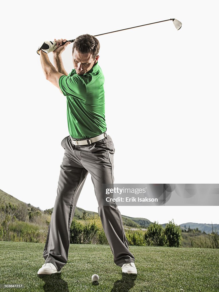 Caucasian man playing golf on course