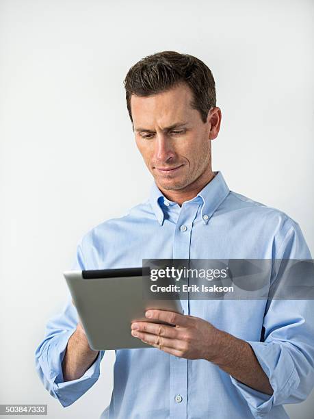 caucasian man using digital tablet - man ipad isolated stock pictures, royalty-free photos & images