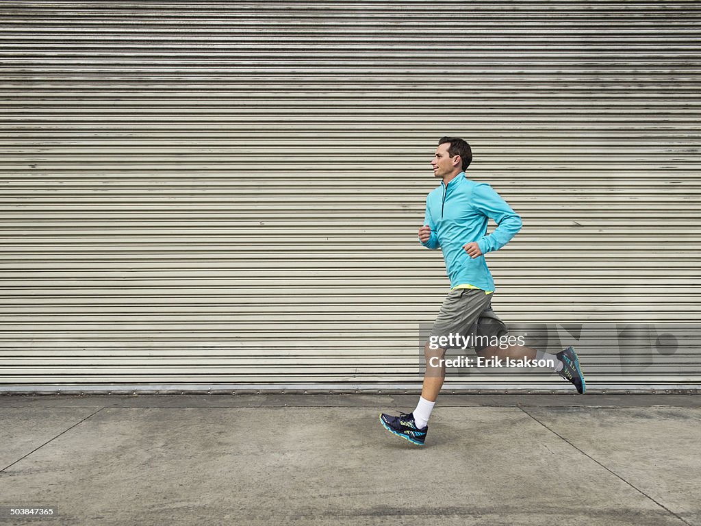 Caucasian man running on city street