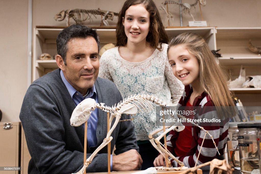 Teacher and students smiling in natural history museum