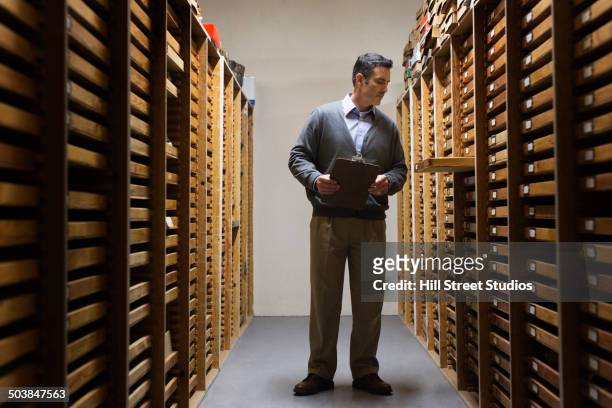 man working in museum archive - treasure map stockfoto's en -beelden