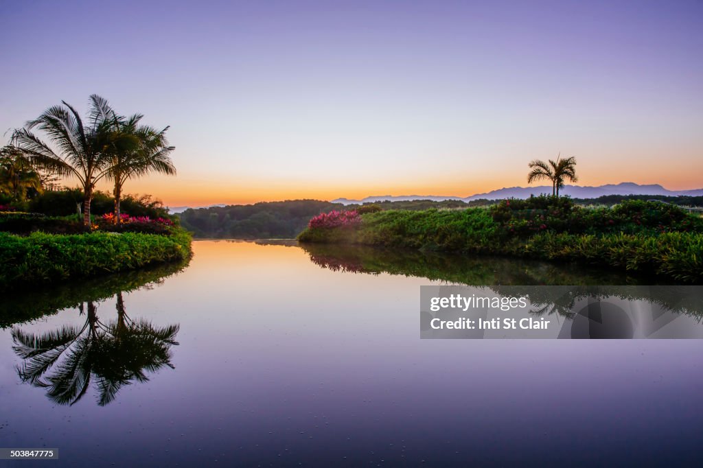 Sky reflected in still tropical lake