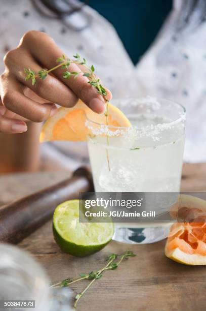 mixed race woman making cocktail - 料理の付け合わせ ストックフォトと画像