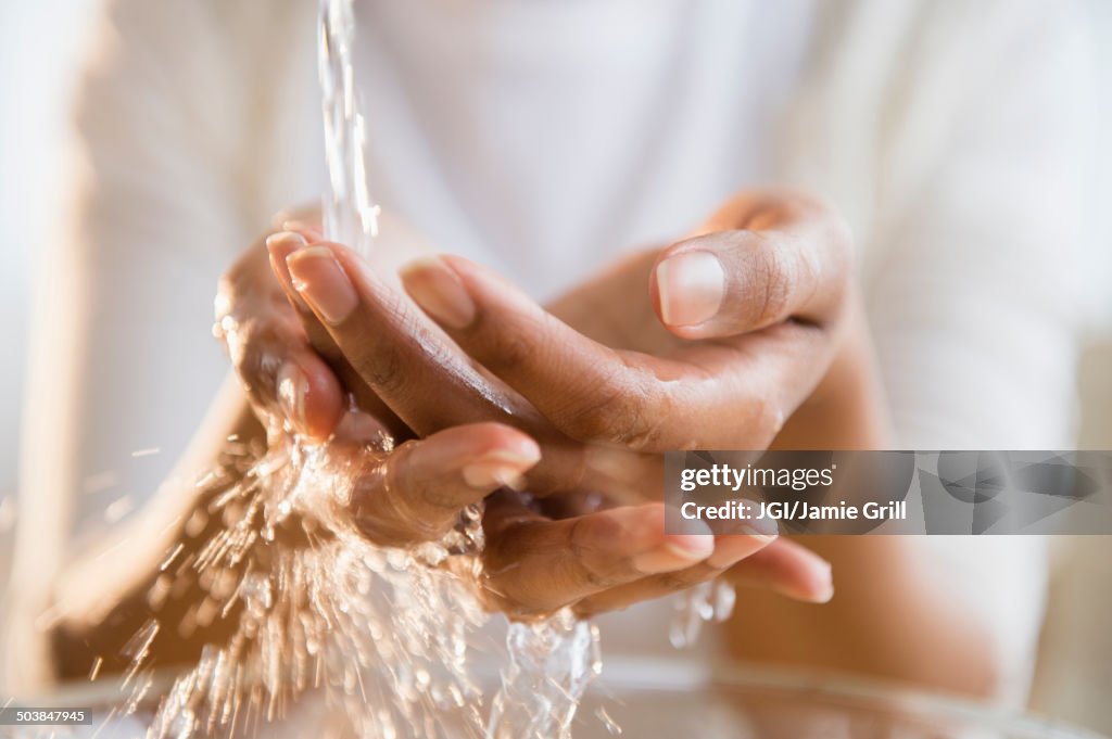 Mixed race woman washing her hands