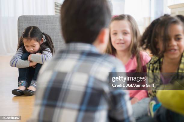 children excluding girl in group - friends loneliness imagens e fotografias de stock