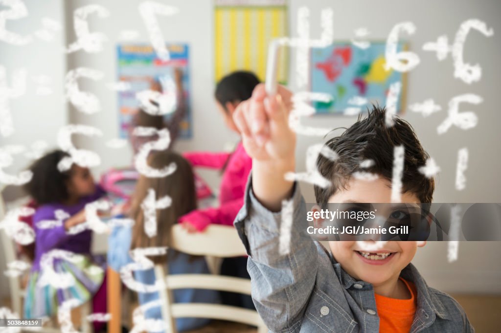 Boy doing math problems in classroom