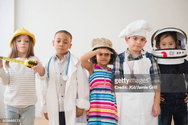 children playing dress up together - verschillende beroepen stockfoto's en -beelden