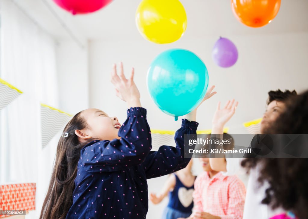 Children playing with colorful balloons at party