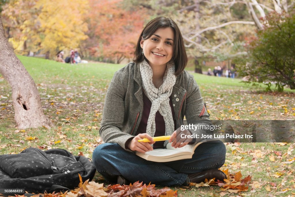 Caucasian student reading in urban park