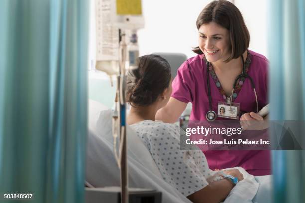 nurse talking to patient in hospital - nurse and patient stockfoto's en -beelden