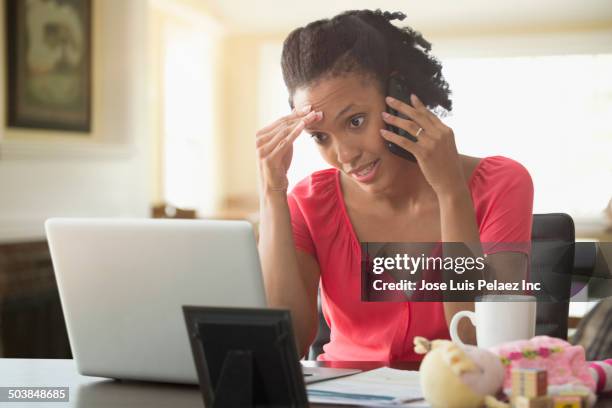 black woman talking on cell phone - laptop frustration stock pictures, royalty-free photos & images