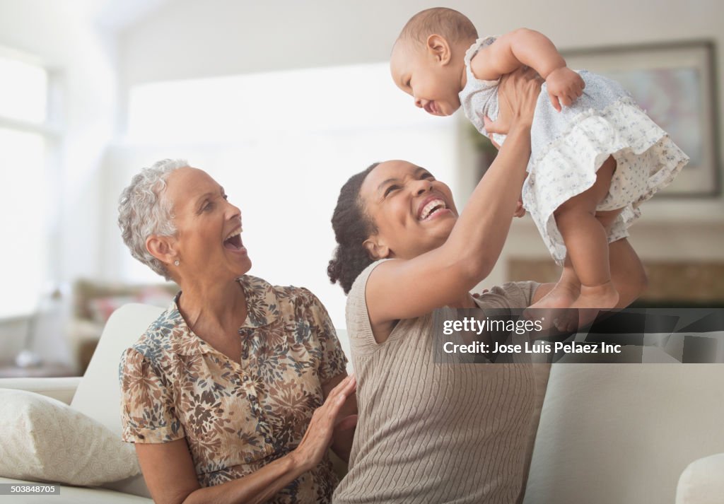 Three generations of women playing on sofa