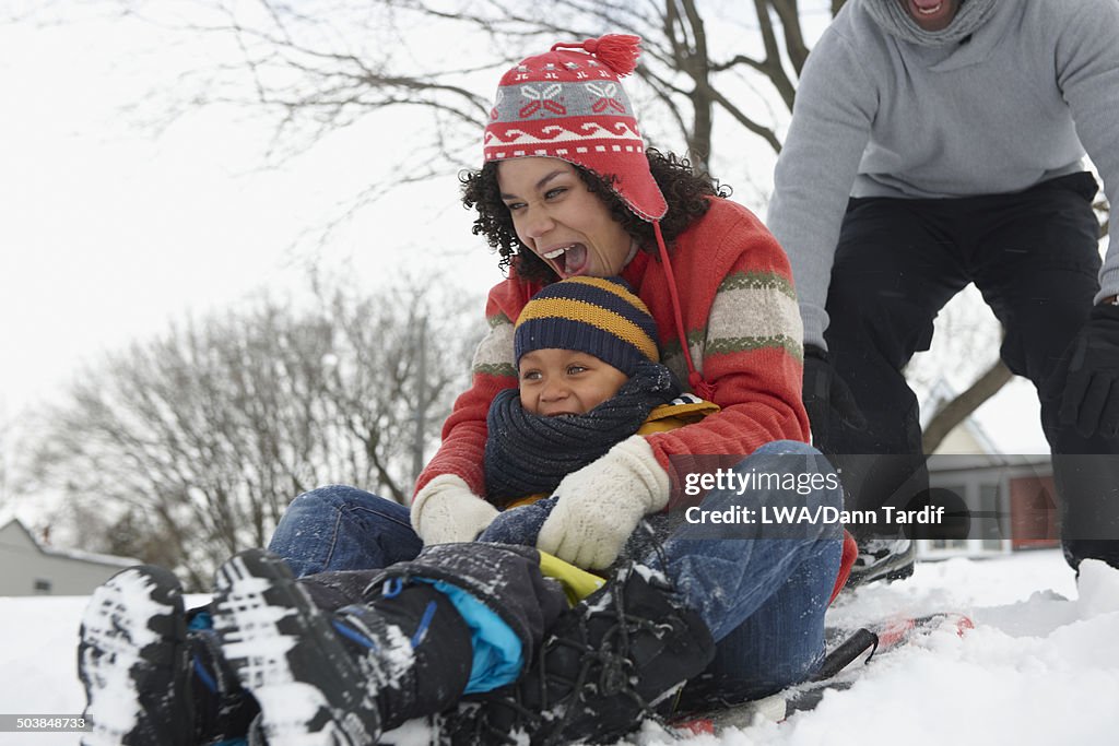 Black family playing in snow