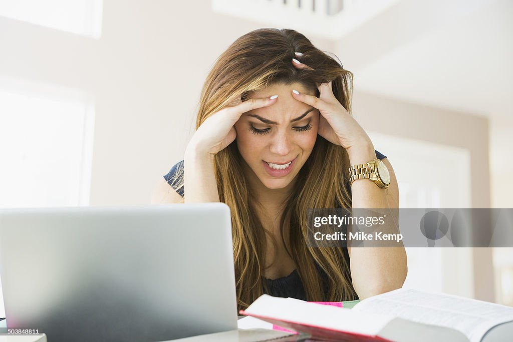 Mixed race woman studying at home