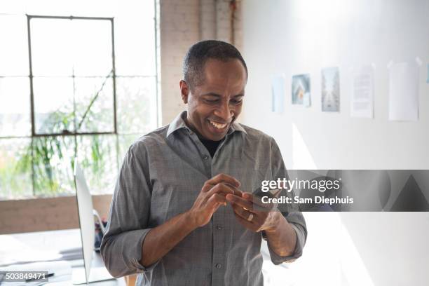 african american architect using cell phone in office - samuser stock pictures, royalty-free photos & images