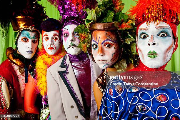 clowns wearing theatrical makeup - zirkuskünstler stock-fotos und bilder