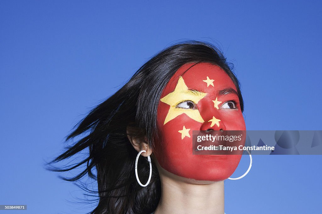 Chinese girl with Chinese flag painted on face
