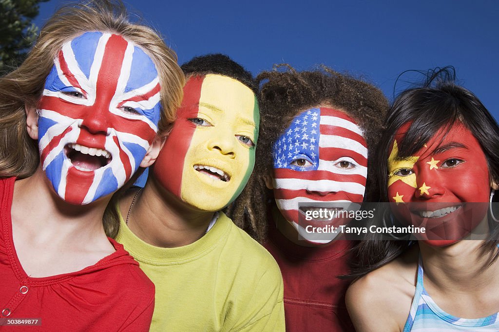 Children with United Kingdom, Guinean, United States and Chinese flags painted on faces