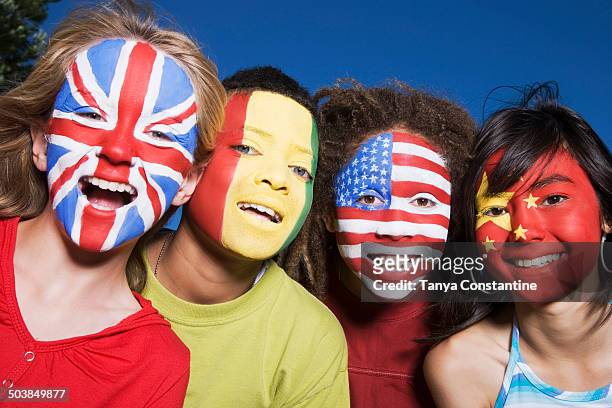 children with united kingdom, guinean, united states and chinese flags painted on faces - national flag day stock pictures, royalty-free photos & images