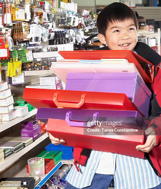 chinese boy buying school supplies in store - excess product stock pictures, royalty-free photos & images