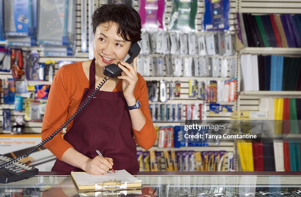 Chinese woman working in office supply store